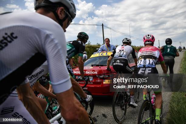 Riders of the pack wait for the race to resume, after General Director of the Tour de France, France's Christian Prudhomme halted it, following a...