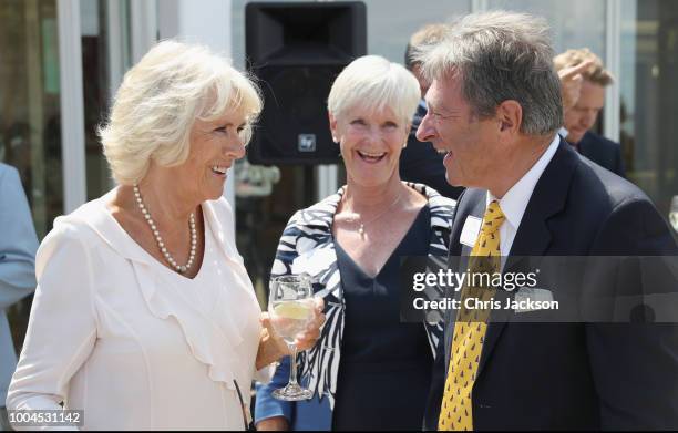 Camilla, Duchess of Cornwall speaks to Alan Titchmarsh and his wife Alison Titchmarsh as she attends a reception at the Royal Yacht Squadron on July...