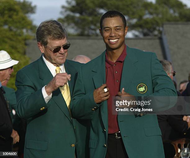 Tiger Woods of the USA is presented with his green jacket by Hootie Johnson after winning the Masters Tournament from the Augusta National Golf Club...