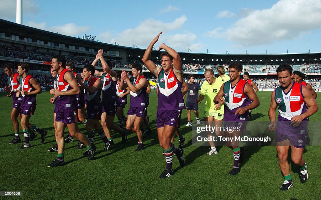 07 Apr 2002:  The Fremantle Dockers team leave the field after winning the round two AFL match betwe