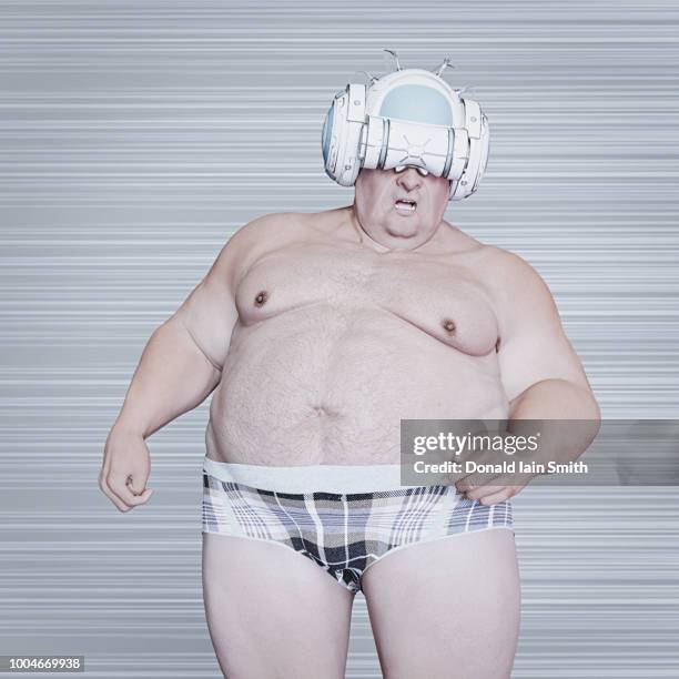 virtual worlds: older fat man wearing vr helmet and underpants - ugly fat guy stock pictures, royalty-free photos & images