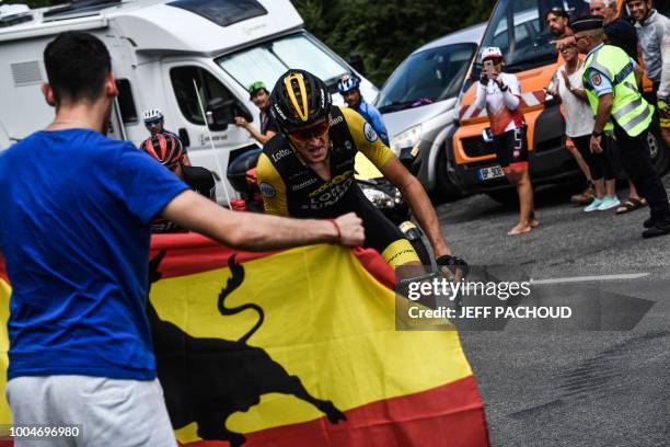 Spectator waves the Spanish flag as Netherlands' Robert Gesink rides during a breakaway in the 16th stage of the 105th edition of the Tour de France...