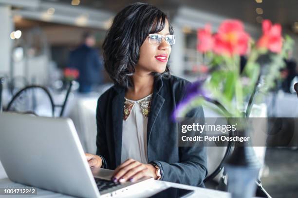 a young indian woman working in a restaurant. - young professionals in resturant stock pictures, royalty-free photos & images