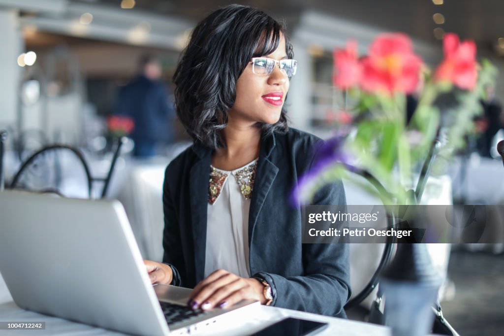 A Young Indian woman working in a restaurant.