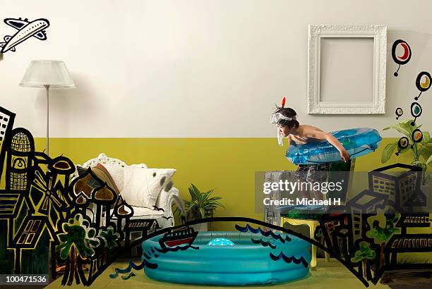 boy who tries to take a plunge into a pool - crazy pool foto e immagini stock