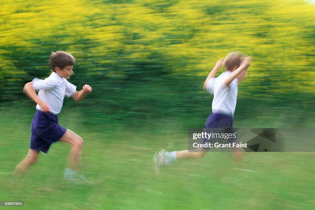 BOYS RUN IN FIELD