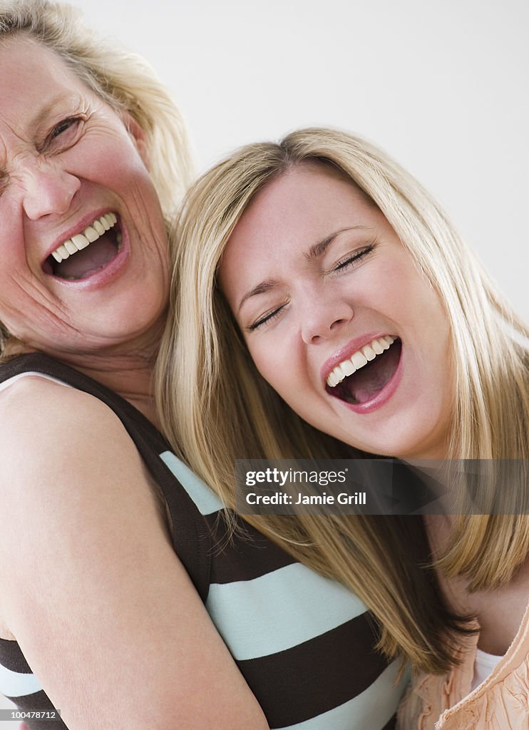 Mother and adult daughter, laughing