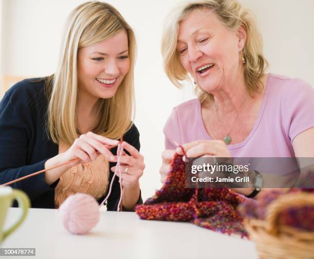 mother teaching daughter how to knit - knitting stock pictures, royalty-free photos & images