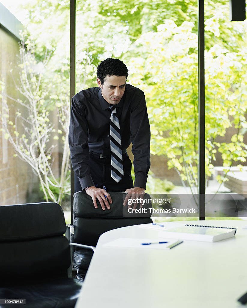 Businessman standing examining documents