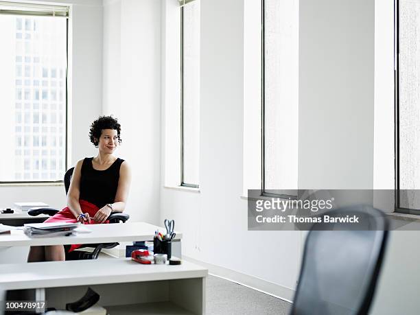 businesswoman sitting at desk in office - office desk top view fotografías e imágenes de stock