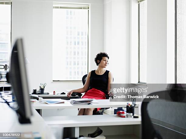 businesswoman sitting at desk in office - bored at work stock pictures, royalty-free photos & images
