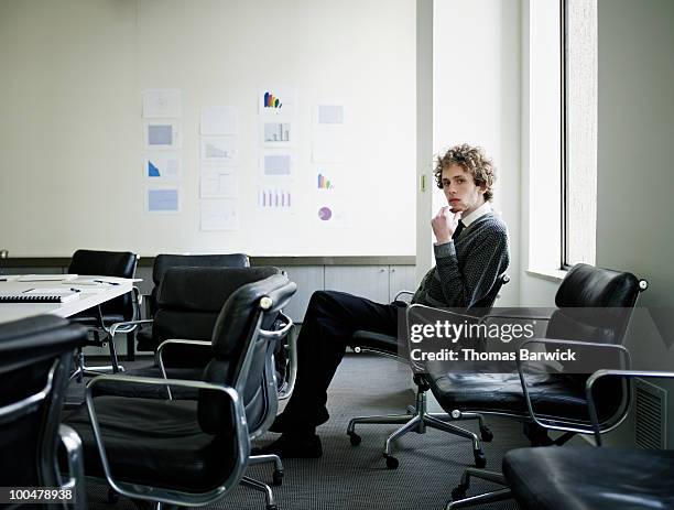 businessman sitting in office chair - empty office one person stock pictures, royalty-free photos & images