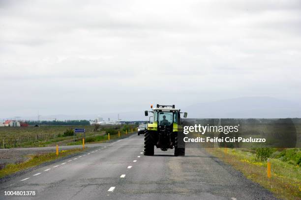 a tractor on the road near selfoss, iceland - nationale snelweg stockfoto's en -beelden
