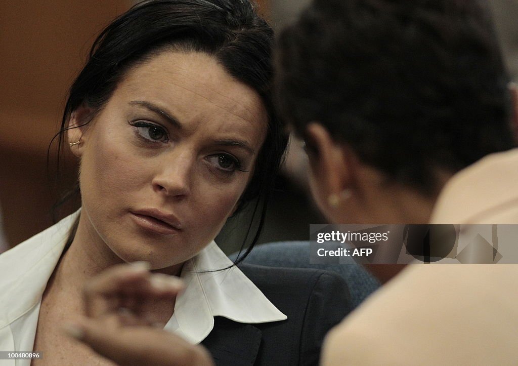 Lindsay Lohan (L) talks with her lawyer