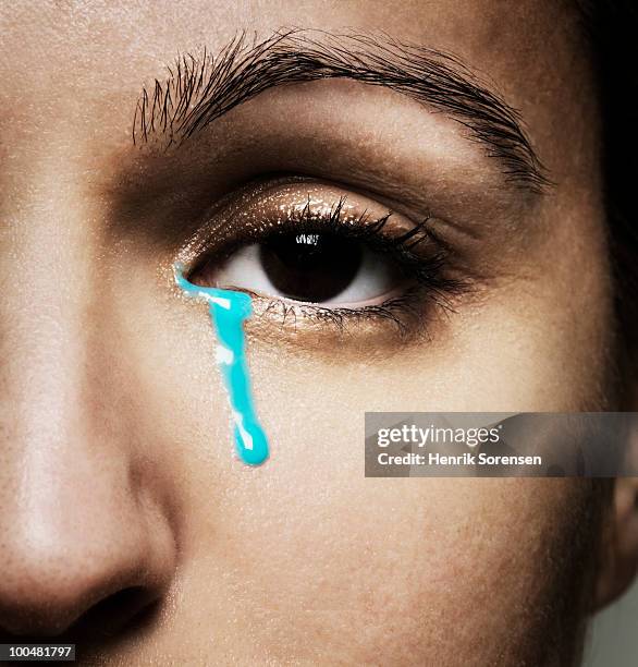 female crying blue tears - teardrop stockfoto's en -beelden
