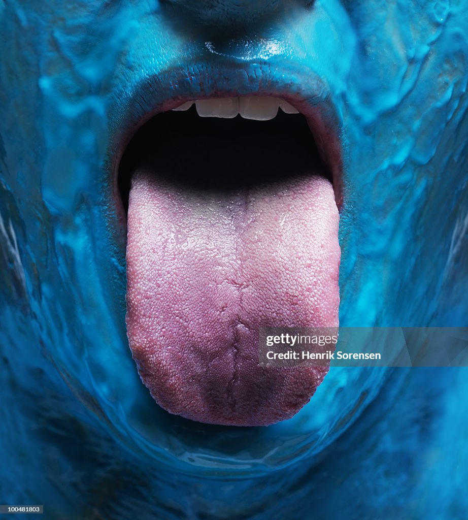 Blue face with out stretched tongue close up