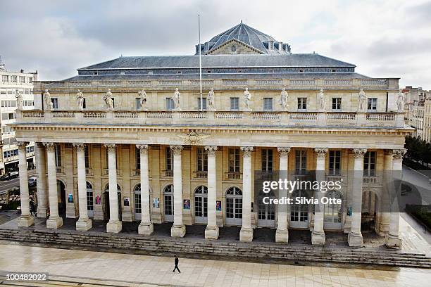man walking in front of theatre - bordeaux square stock pictures, royalty-free photos & images
