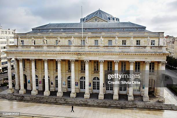 man walking in front of theatre - plaza theatre stock pictures, royalty-free photos & images