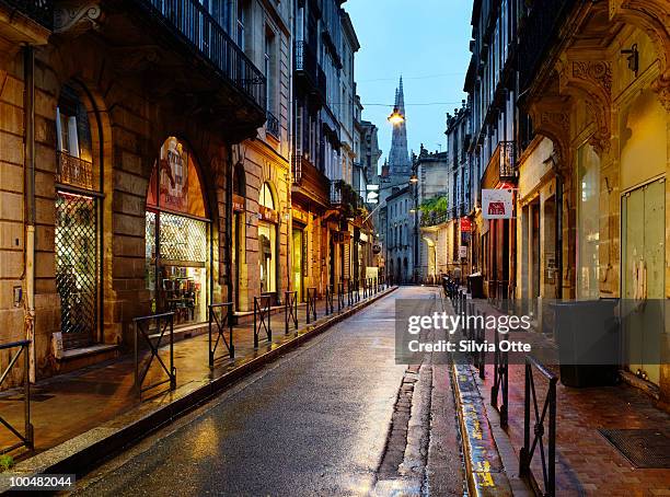wet downtown street - bordeaux street stock pictures, royalty-free photos & images
