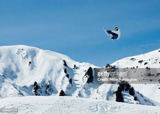 male snowboarder in the air against blue sky - snowboard jump bildbanksfoton och bilder