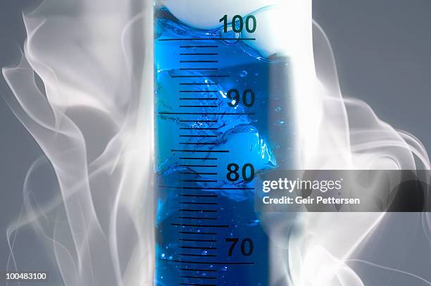 smoke around cylinder with blue liquid - measuring cylinder stock pictures, royalty-free photos & images