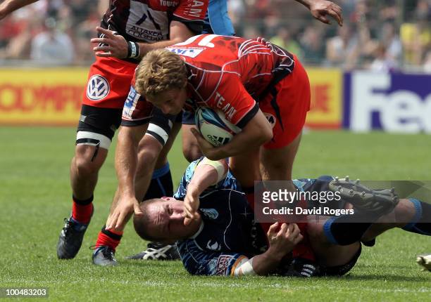 Jonny Wilkinson of Toulon is tackled by Gethin Jenkins during the Amlin Challenge Cup Final between Toulon and Cardiff Blues at Stade Velodrome on...