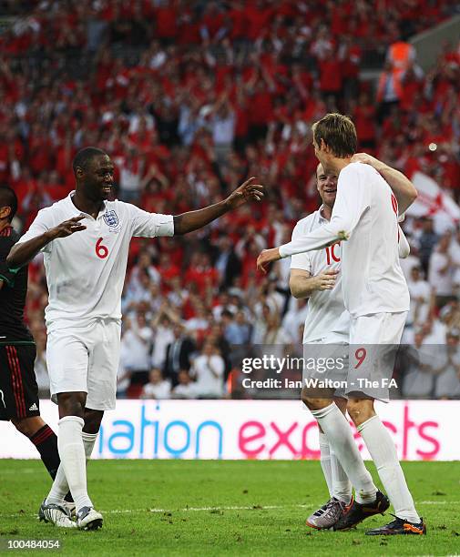 Peter Crouch of England celebrates with Ledley King and Wayne Rooney after scoring his sides second goal during the International Friendly match...