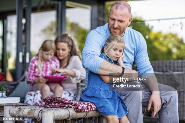 beautiful mother, handsome father and two young blonde daughters enjoying family life in their house - dutch culture stock pictures, royalty-free photos & images