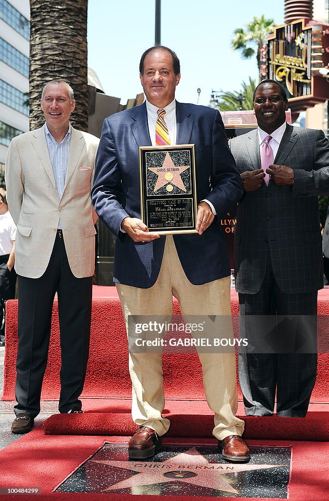 ESPN sportscaster Chris Berman (C) poses