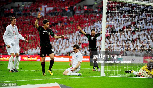 Guillermo Franco of Mexico celebrates his goal as Peter Crouch and Leighton Baines of England look on during the International Friendly match between...