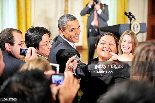 President Barack Obama greets people during a reception to celebrate Asian Pacific American Heritage Month in the East Room of the White House on May...