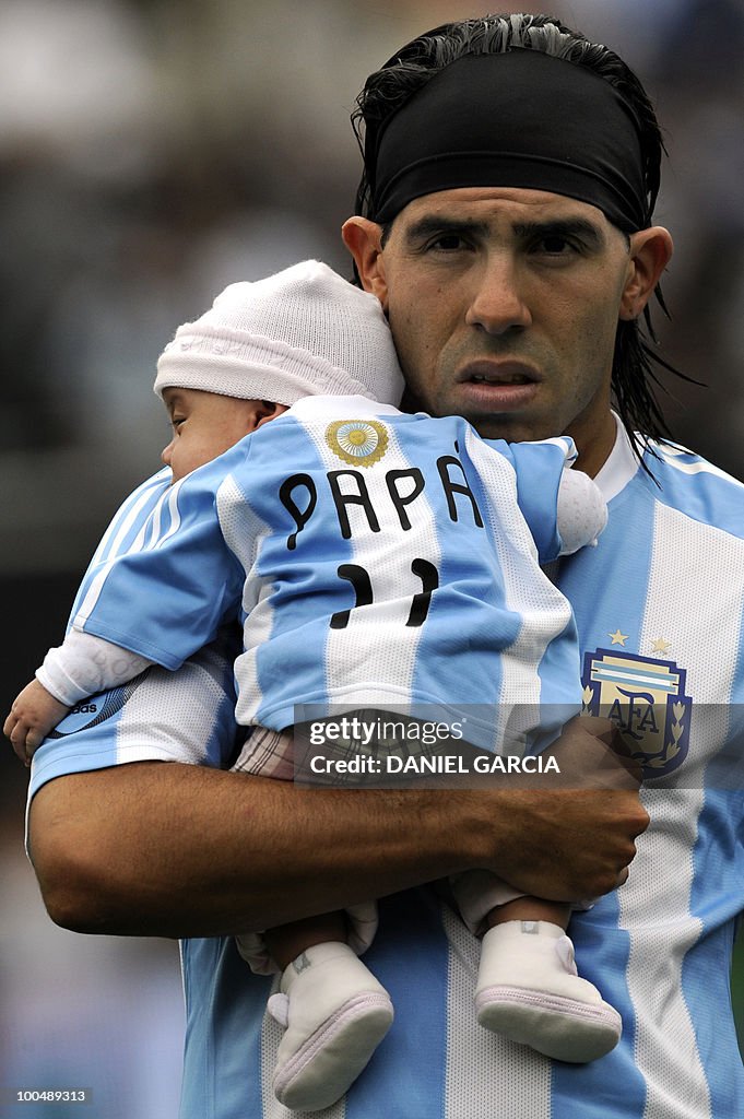 Argentina's forward Carlos Tevez carries