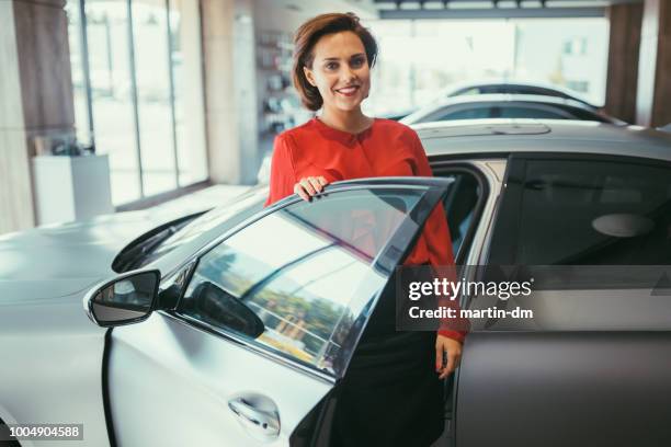 businesswoman buying new car - automotive sales stock pictures, royalty-free photos & images