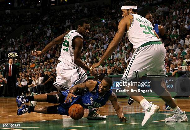 Jameer Nelson of the Orlando Magic loses the ball as he drives against Tony ALlen and Rasheed Wallace of the Boston Celtics in Game Four of the...