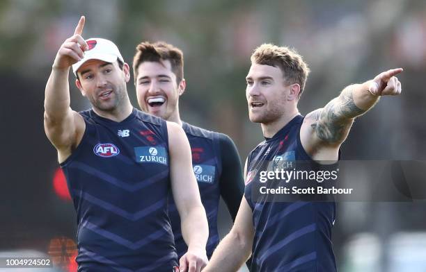 Jordan Lewis of the Demons, Alex Neal-Bullen of the Demons and Dean Kent of the Demons talk during a Melbourne Demons AFL training session at Gosch's...