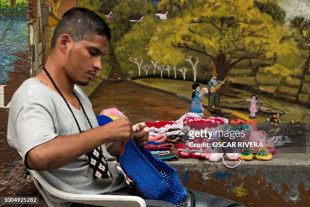 Former gang member crochets during a workshop at the prison of San Francisco Gotera, 161 km east of San Salvador on July 16, 2018. Members of two of...