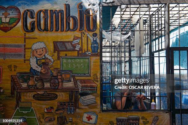 Former gang member is pictured at the prison of San Francisco Gotera, 161 km east of San Salvador on July 16, 2018. - Members of two of the world's...