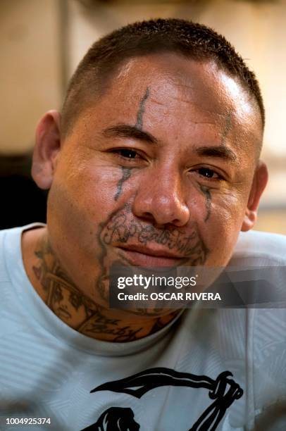 Former gang member is pictured at the prison of San Francisco Gotera, 161 km east of San Salvador, on July 16, 2018. - Members of two of the world's...