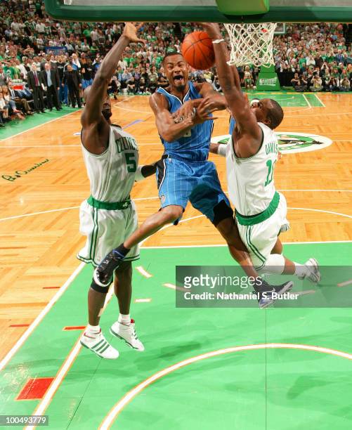 Rashard Lewis of the Orlando Magic loses control of the ball and commits a turnover while defended by Kevin Garnett and Glen Davis of the Boston...