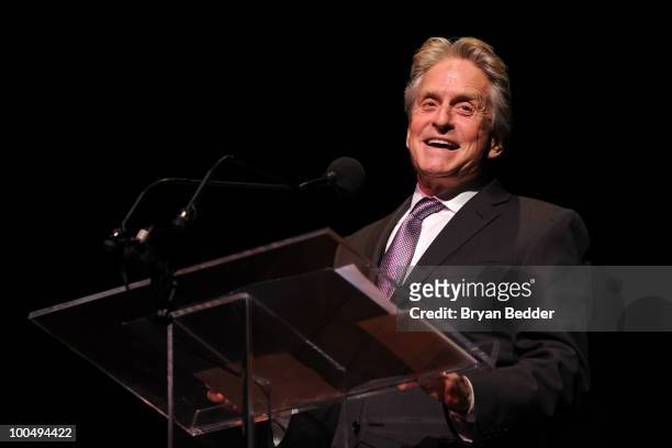 Actor Michael Douglas waves onstage while being honored at the The Film Society of Lincoln Center's 37th Annual Chaplin Award gala at Alice Tully...