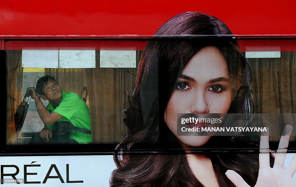 A Thai man peeks out of a bus in Bangkok