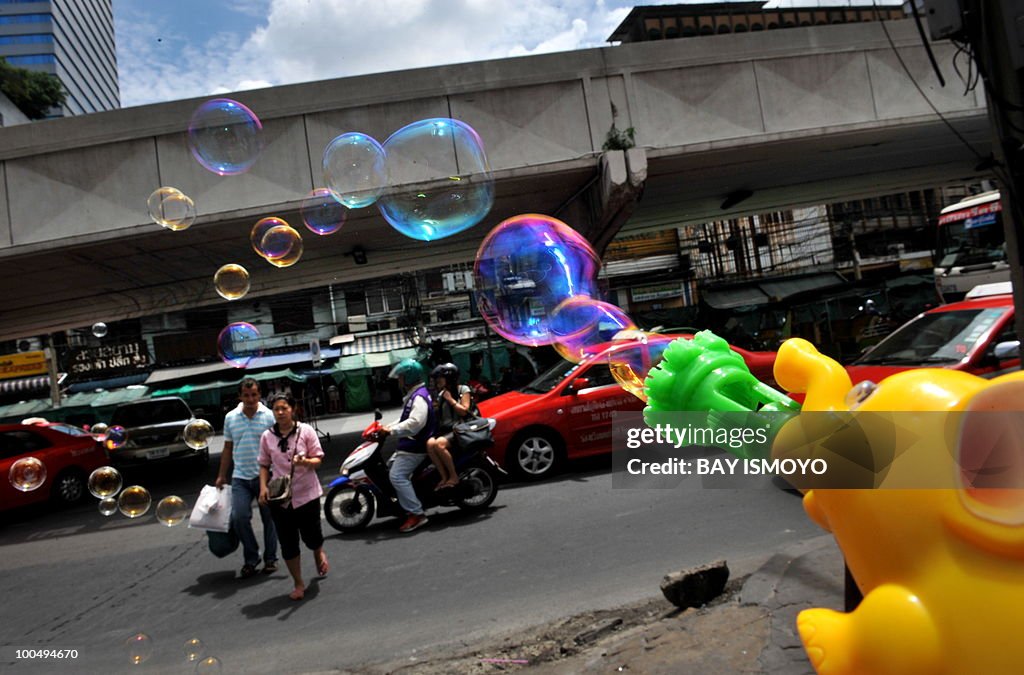 Bubbles float past a couple crossing the