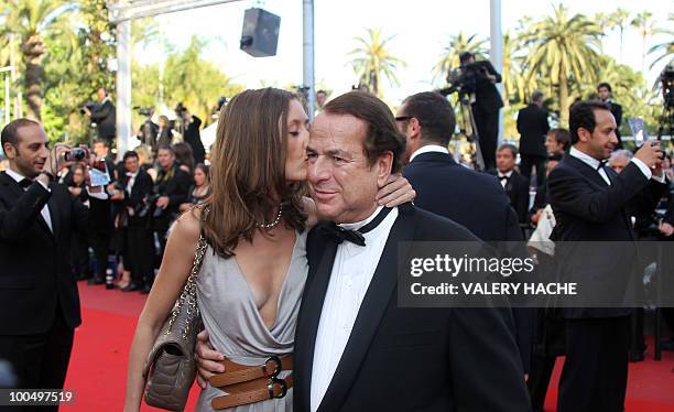 Paul-Loup Sulitzer is kissed by companion finance consultant Annabelle Rahal as they arrive for the screening of "Utomlyonnye Solntsem 2:...