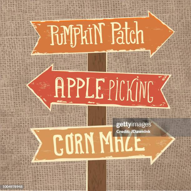 wooden sign post with arrows pointing to pumpkin patch, apple picking and corn maze - pumpkin picking stock illustrations