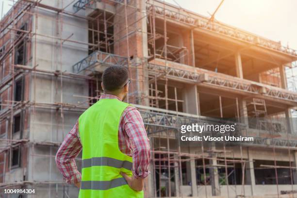 engineer architect on a building construction site - building site accidents stock pictures, royalty-free photos & images