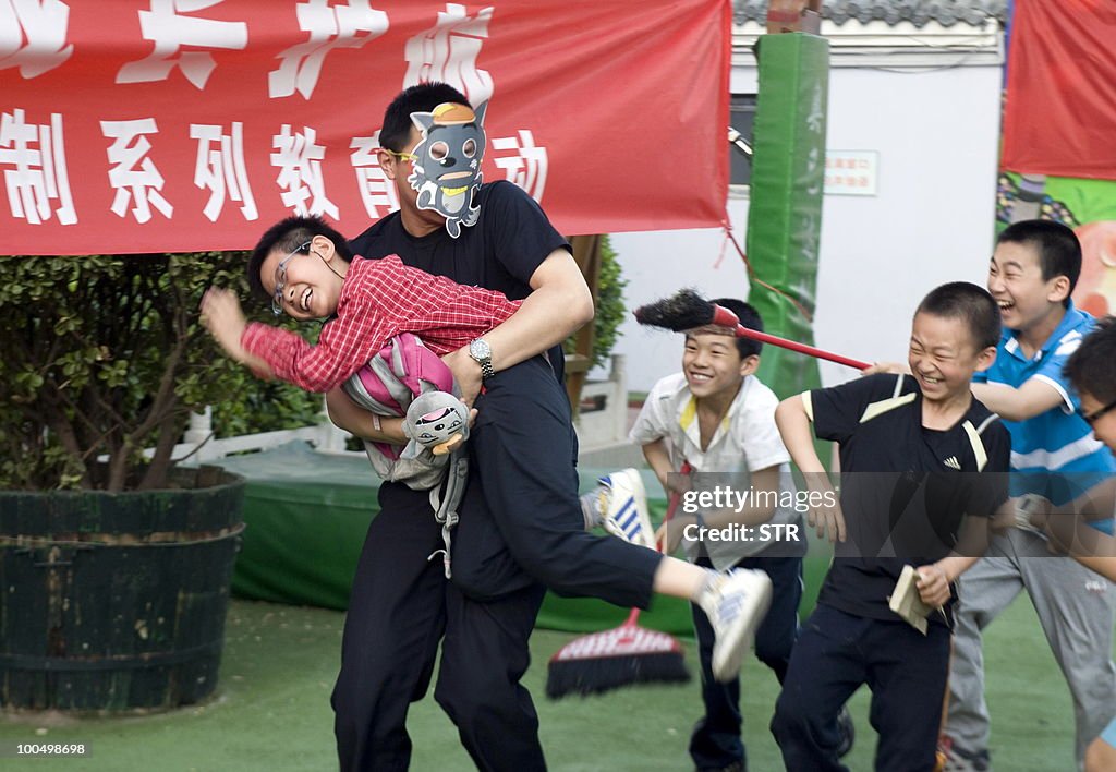 A Chinese parent shows school children a