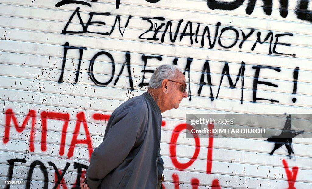 A man walks in downtown Athens on May 2,