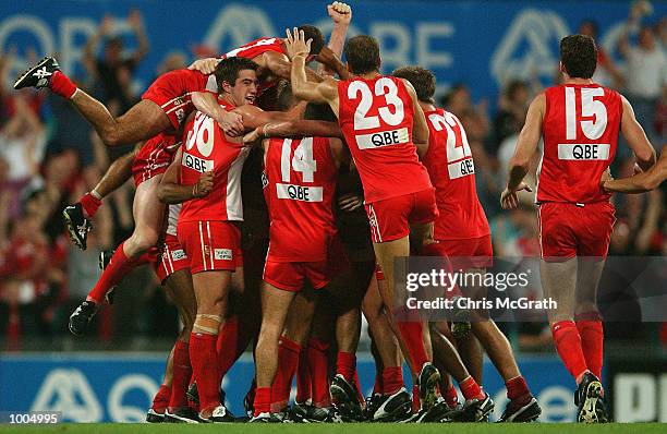 Daryn Creswell is mobbed by team mates after he kicked a goal after the siren to win the match during the round 4 AFL match between the Sydney Swans...