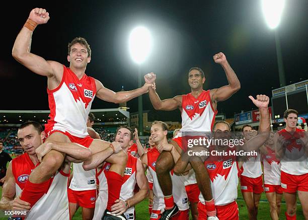 Andrew Dunkley of the Swans and Michael O''Loughlin are chaired from the field during the round 4 AFL match between the Sydney Swans and the...