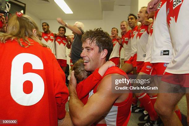 Andrew Dunkley of the Swans celebrates 200 games with his kids as his team mates celebrate their win during the round 4 AFL match between the Sydney...